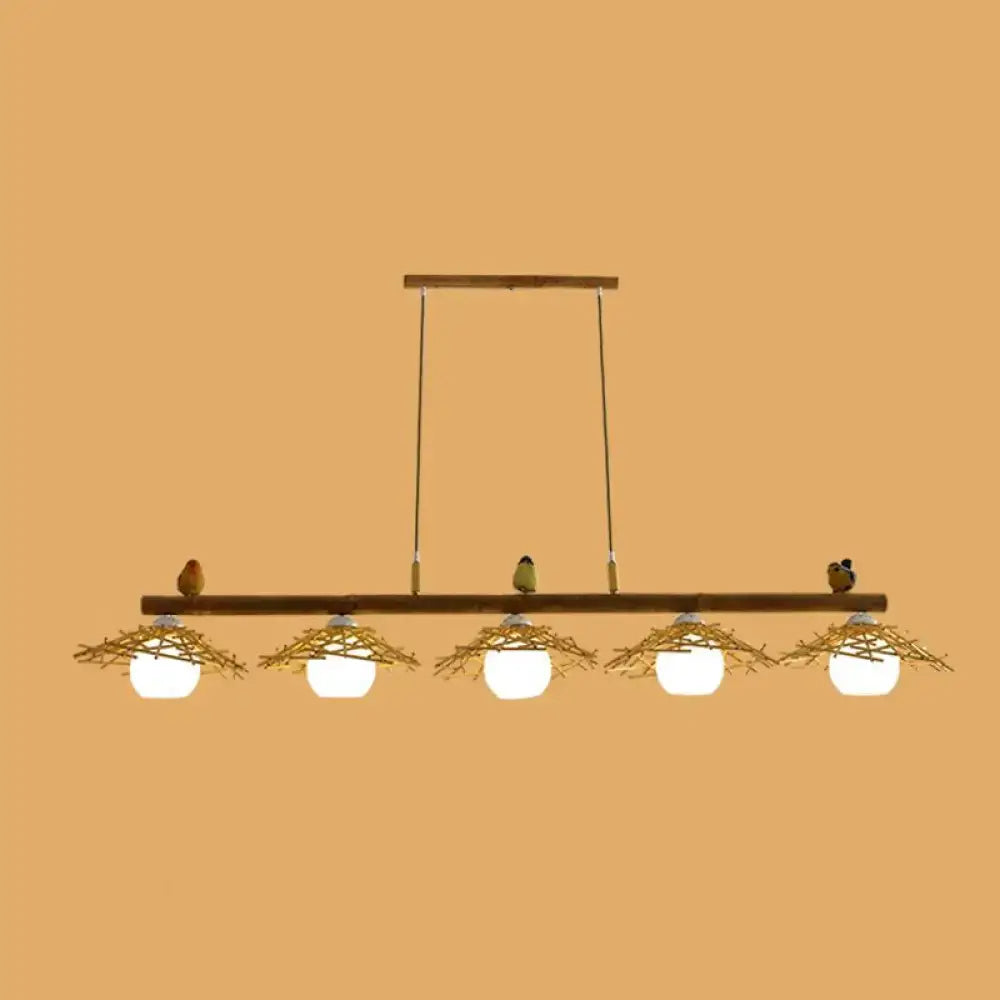 DecorBites bamboo pendant lighting with five white glass globe bulbs in woven twig nests and decorative birds art deco style