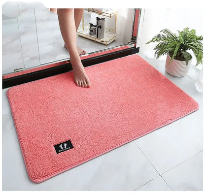 Pink rectangular decorbites bathroom mat with plush texture and black welcome patch super non slip and absorbent