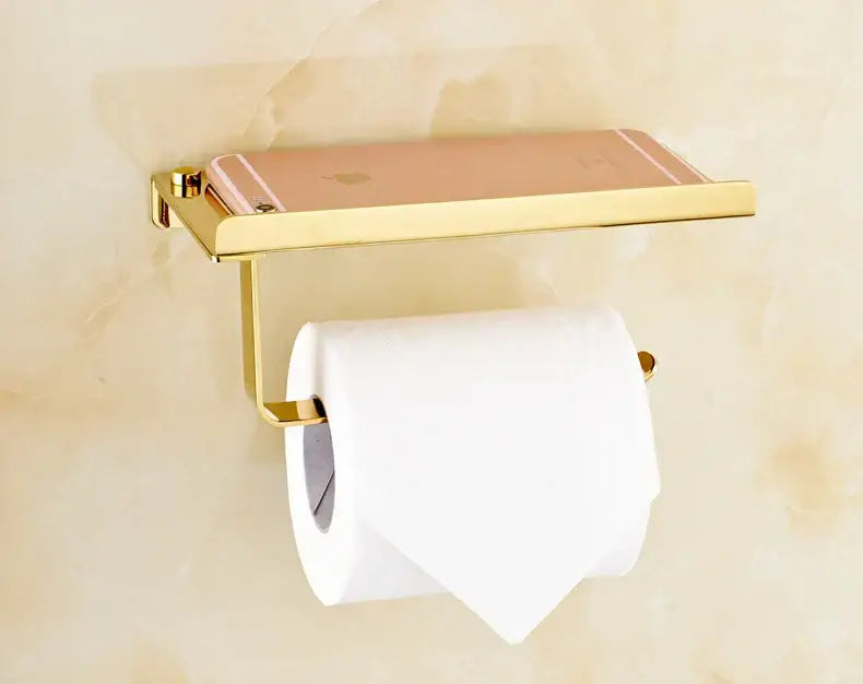 Gold-toned decorbites bathroom paper phone holder shelf and toilet paper holder set with rose gold iphone resting on shelf