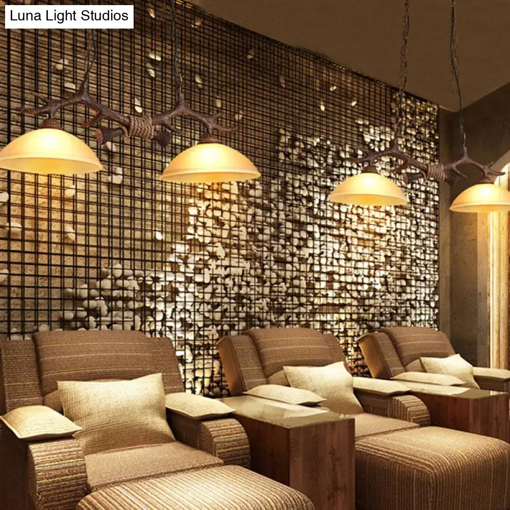 DecorBites beige glass ceiling light with dark coffee antler-inspired pendant lights and warm yellow shades hanging in restaurant