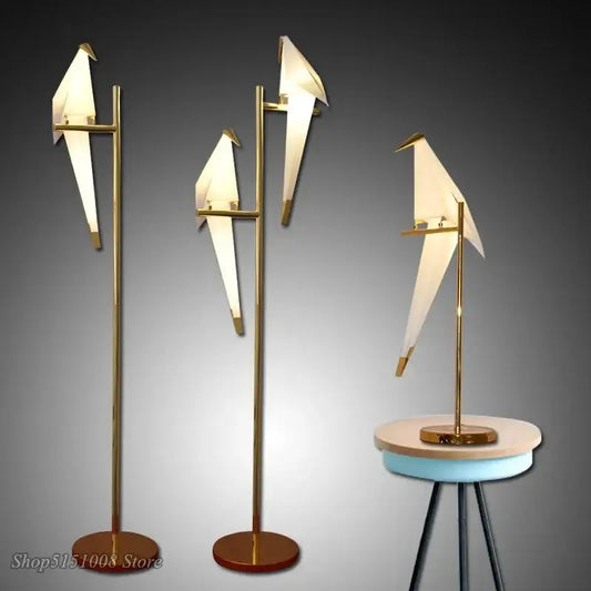 Gold-toned decorbites bird origami floor lamp with illuminated white paper wings and sleek metallic stand for living room