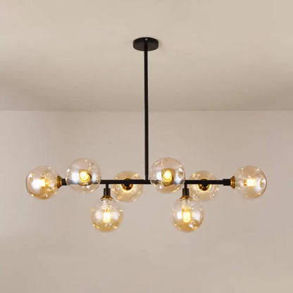 Modern black metal chandelier light type with clear glass globe bulbs and brass accents for dining room island use