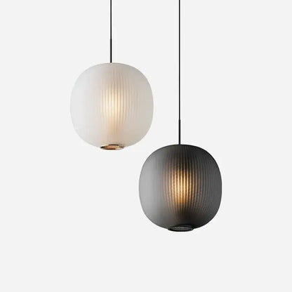 Two spherical pendant table lights with vertical ribbed glass shades in frosted white and matte black decorbites black glass ball