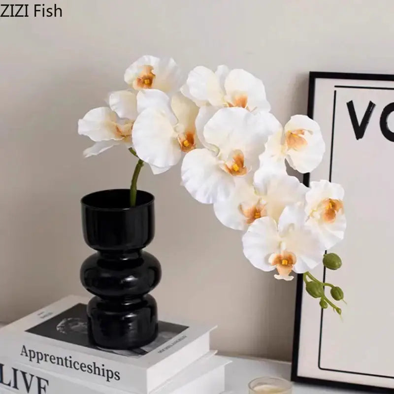 Elegant white orchid artificial flowers in a sleek decorbites black glass tiered vase for minimalist room decor