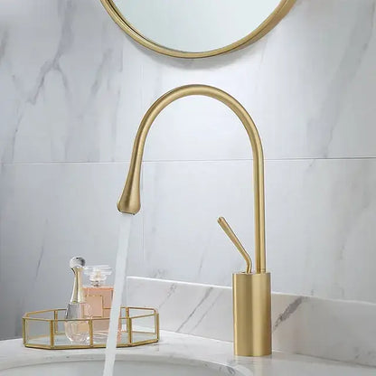 Gold-toned decorbites black gold basin faucet with sleek arched design and brushed metal finish for kitchen sink use