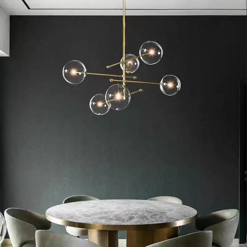 Brass-finished modern chandelier with clear glass globe bulbs in decorbites black gold vintage geometric lighting design
