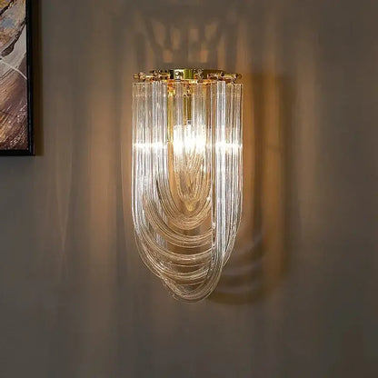 A modern decorbites black gold pendant light with cascading clear glass tubes and gold-toned metal frame