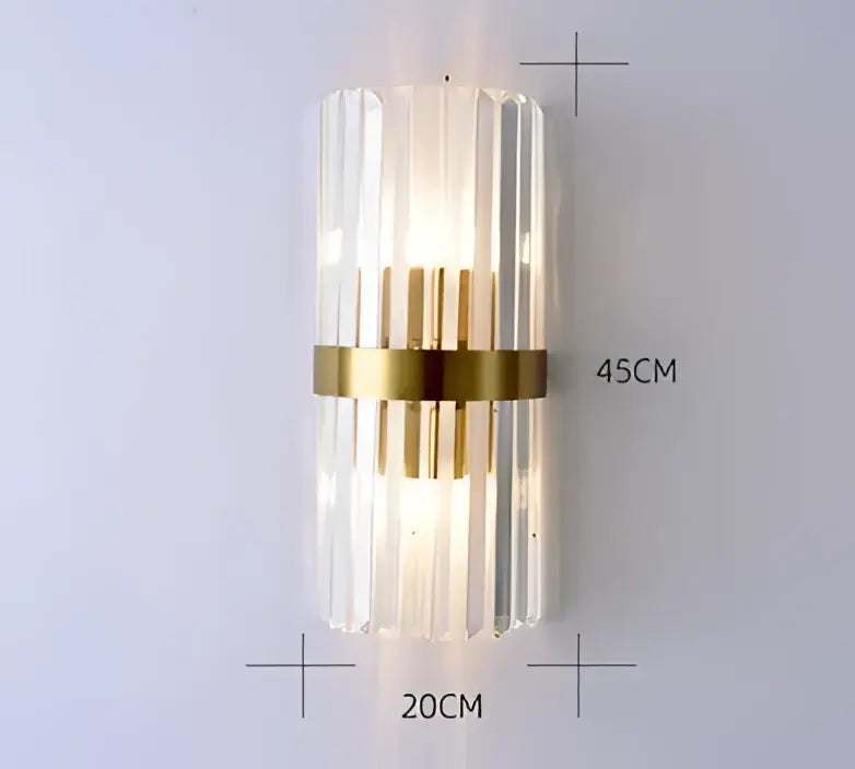A modern decorbites black gold crystal wall light with cylindrical glass prisms and gold-toned band for bedroom lighting
