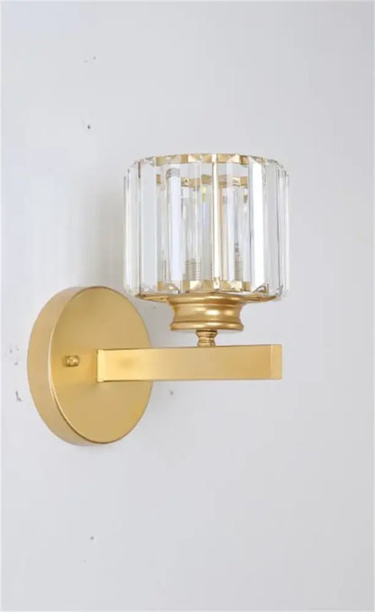 Decorbites black gold crystal wall light with gold finish and cylindrical faceted crystal shade for bedroom and living room