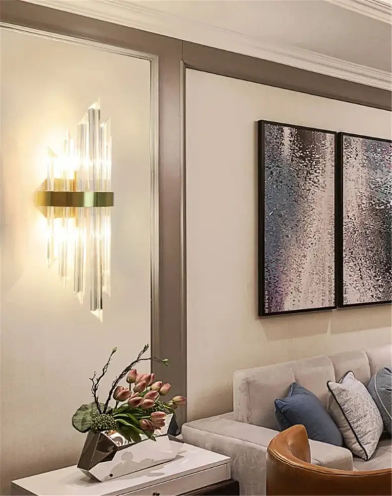 DecorBites black gold crystal wall light with gold-toned sconce and vertical prisms casting warm light for bedroom