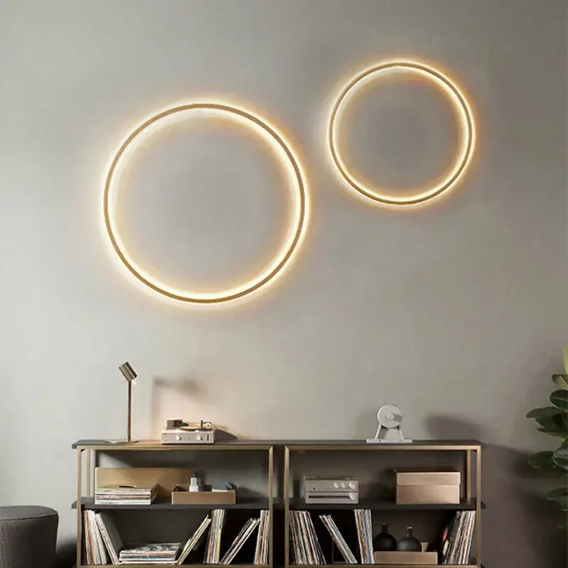 Two circular decorbites black gold dimmable wall lights with warm glowing rings and usb plug for bedroom sconce lighting