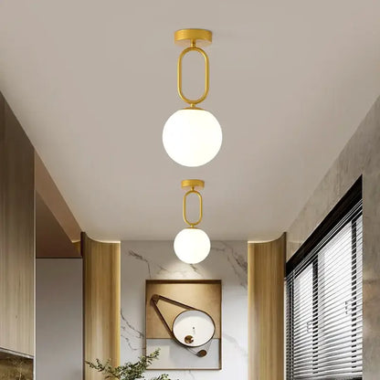 Decorbites black gold glass ceiling lamp featuring gold-finished pendant lights with spherical frosted glass shades
