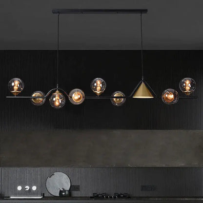 Modern black metal pendant light featuring spherical black gold glass shades and a central gold glass chandelier shade by decorbites black gold