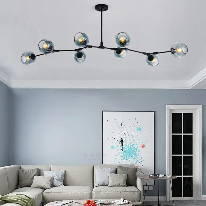 Modern black metal DecorBites black gold pendant light with seven teal glass globes for dining room or loft use