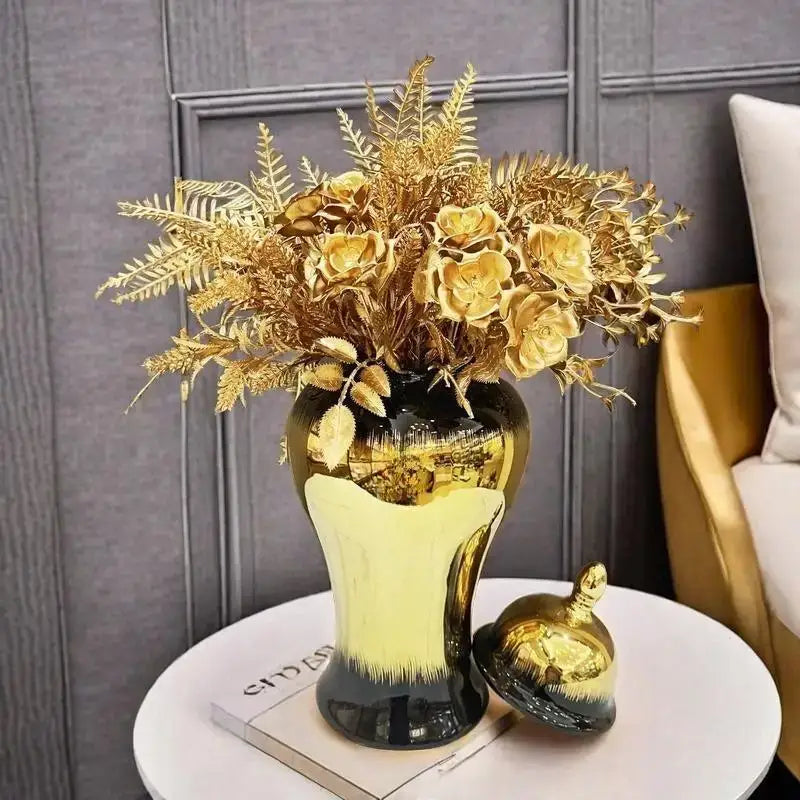 Decorbites black gold gradated ceramic ginger jar with flared opening holding golden faux flowers for home decor