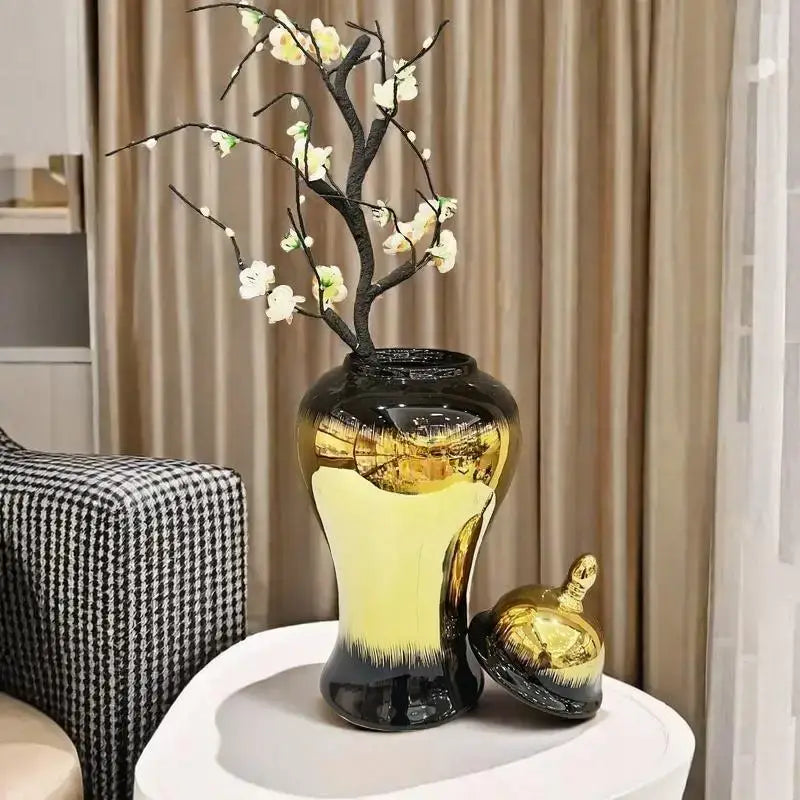 Decorbites black gold gradated ceramic ginger jar vase with glossy finish holding white artificial blossoms on dark branches
