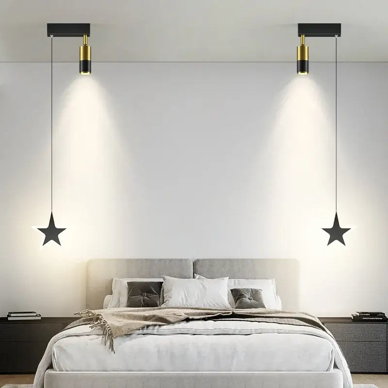 DecorBites black gold hanging pendant lamp features black star-shaped lights with gold accents above a bed for modern luxury