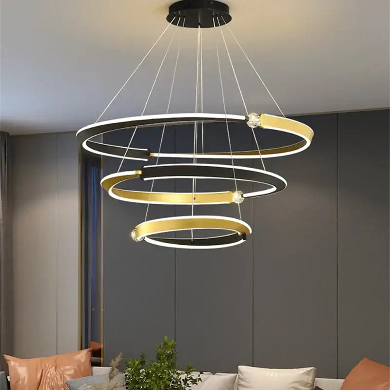 DecorBites black gold LED ceiling chandelier with modern spiral black and gold rings and crystal bead accents