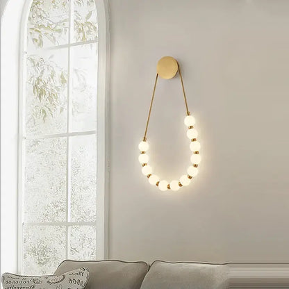 Gold-toned decorbites black gold led wall lamp with spherical bulbs and circular base for bedroom and corridor use