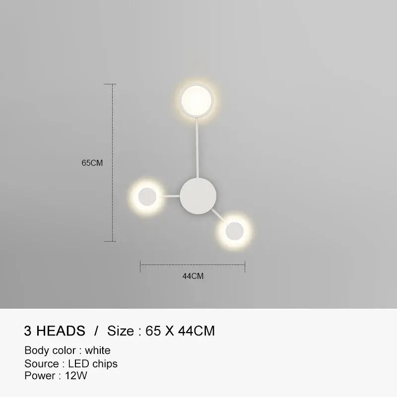White minimalist wall lamp with three glowing led heads in a triangular pattern decorbites black gold led design