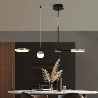 Modern black gold minimalist chandelier featuring three illuminated heads in decorbites black gold design for dining room decor