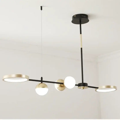 Modern black gold minimalist chandelier featuring circular and spherical illuminated fixtures for dining room decorbites black gold