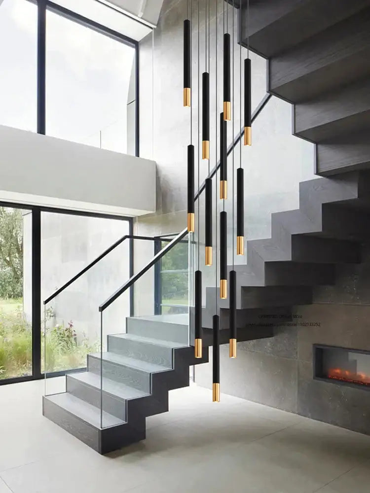 Modern nordic decorbites black gold pendant lamp featuring black gold cylindrical lights in a cascading indoor arrangement