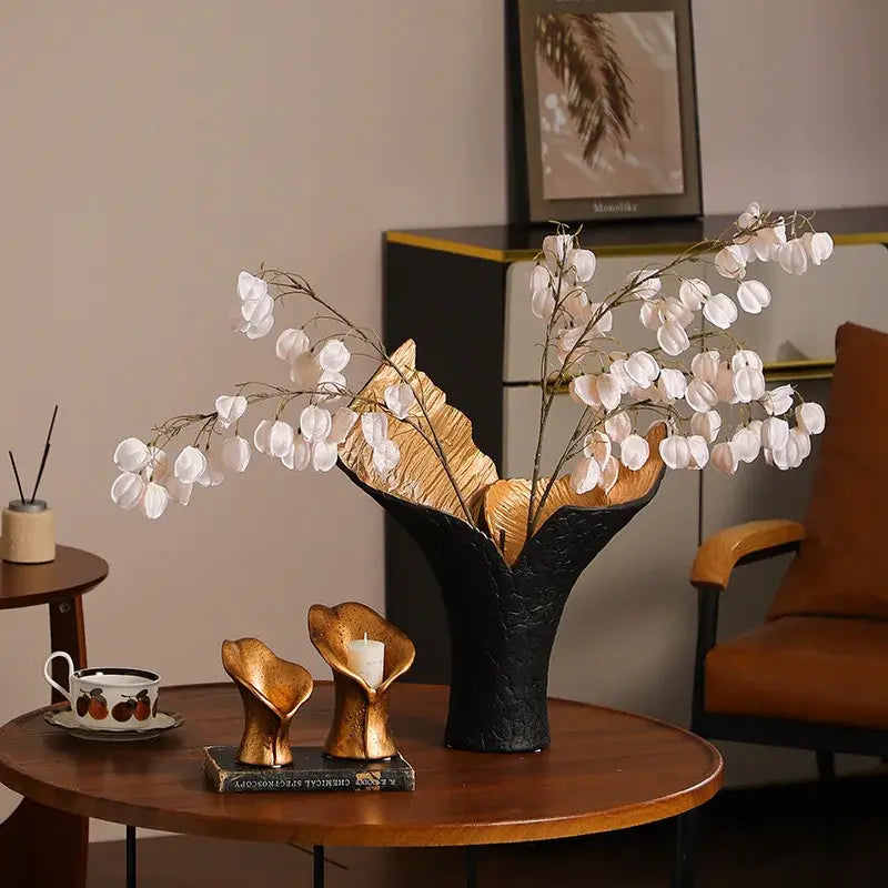 Decorbites black gold resin handicrafts display vase candlestick in black and gold ceramic with leaf-like opening holding white pods