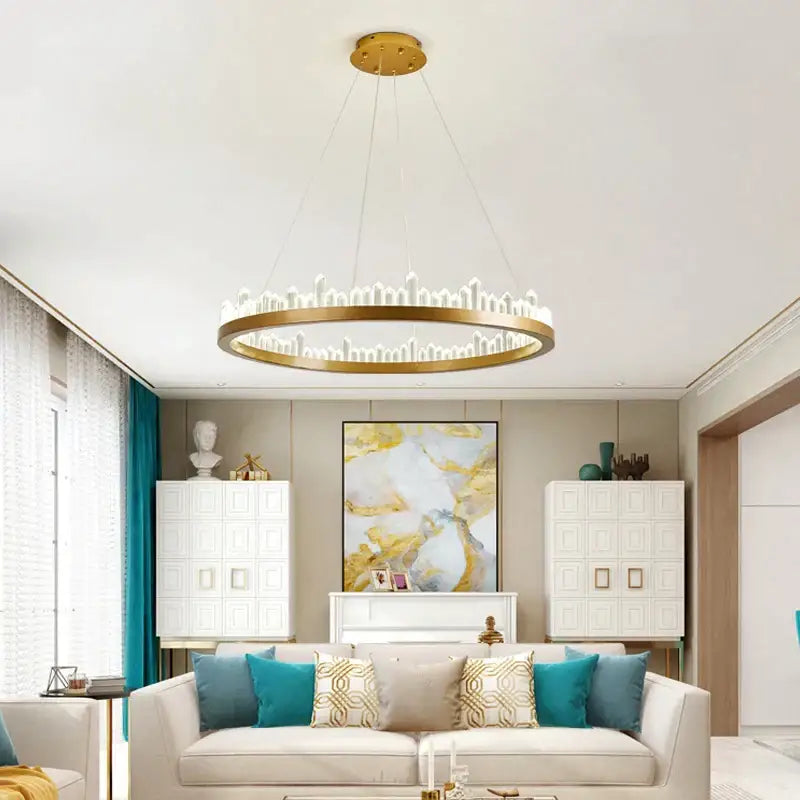 Gold-toned circular pendant light with candle-like led elements from DecorBites black gold rings crystal chandelier