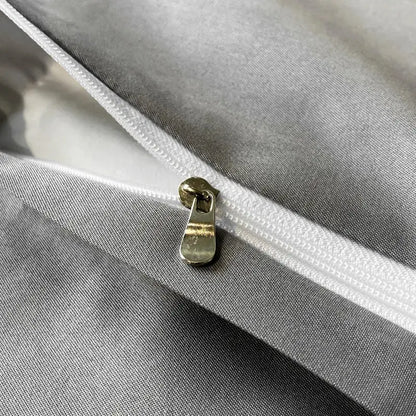 A metallic gold zipper pull on a white zipper track of the DecorBites black grey marble ice silk duvet cover set