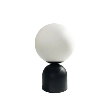 Minimalist DecorBites black iron table lamp with frosted white glass ball shade and sleek black cylindrical base for home decor