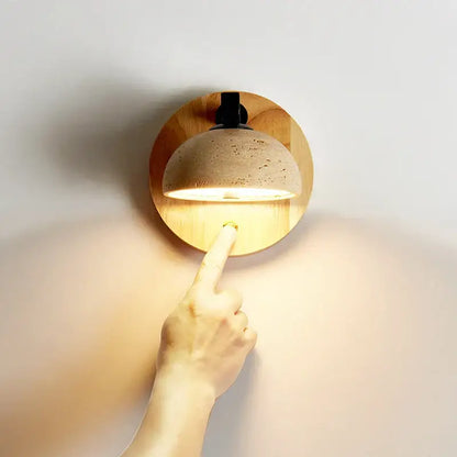 Decorbites black iron led wall lamp with warm-toned dome sconce, textured cork finish, and wooden base for bedside use