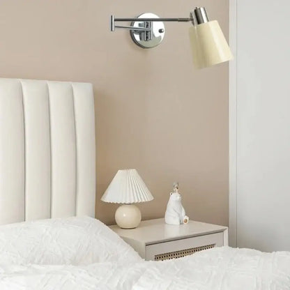 Cream-colored pleated lampshade on rounded white base of decorbites black iron led wall sconce in modern nordic style
