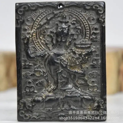 Dark metallic rectangular pendant with intricately carved deity and circular halo from decorbites black iron meteorite sun collection