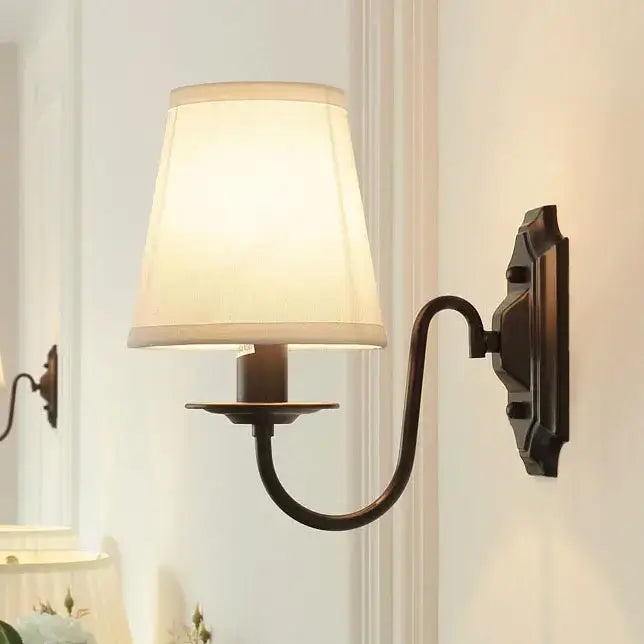 Antique bronze-finished DecorBites black iron wall lamp with off-white fabric shade for elegant bedroom and living room decor