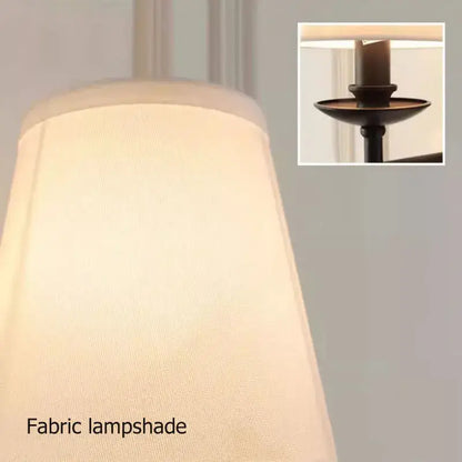 Cream-colored textured fabric lampshade with subtle sheen on decorbites black iron wall lamp for bedroom and living room