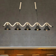 DecorBites black island pendant features five black metal shades suspended by hemp rope with brass accents