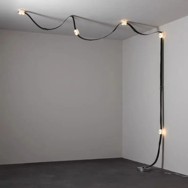 Decorbites black leather marble chandeliers feature a curved minimalist black leather cord with integrated circular lights