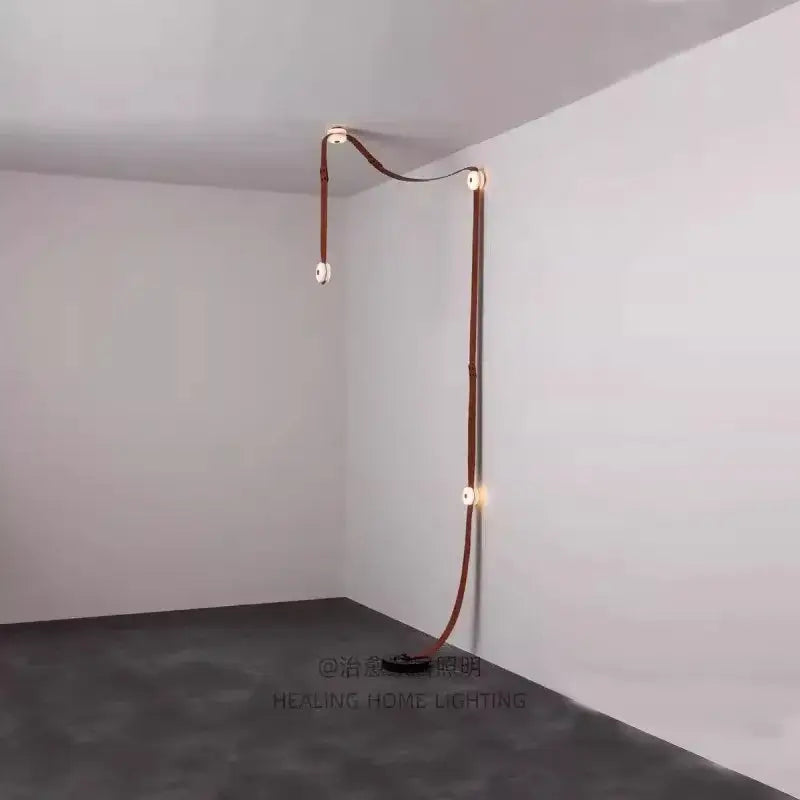 A copper-toned leather-wrapped led wall sconce with minimalist design by decorbites black leather marble chandeliers