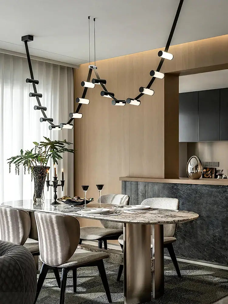 Modern black leather pendant light by DecorBites featuring cylindrical fixtures on an angular frame for dining room decor