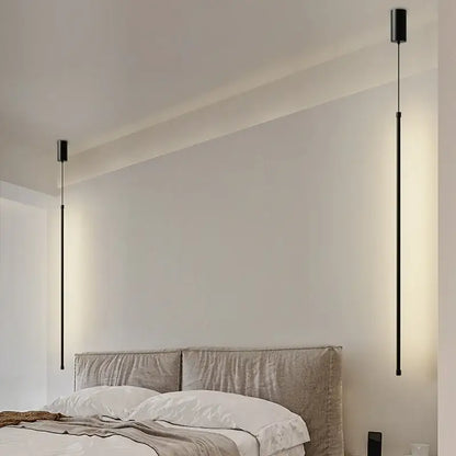 Two sleek black pendant lights with slim rods and warm glow featured in DecorBites black led chandelier for dining room