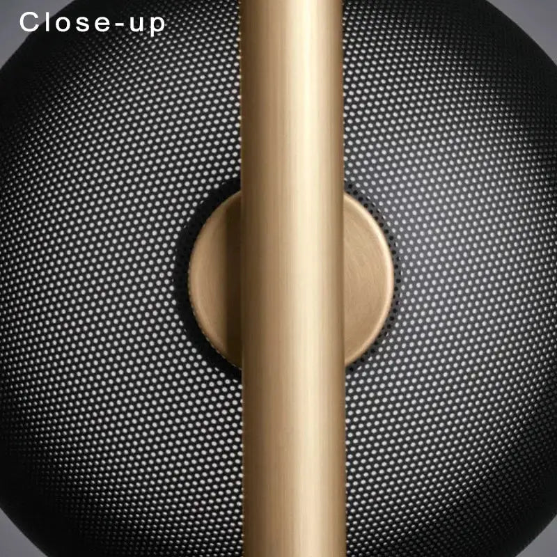 Gold-toned cylindrical lamp fixture with black perforated mesh shade on decorbites black led floor lamp for modern living rooms