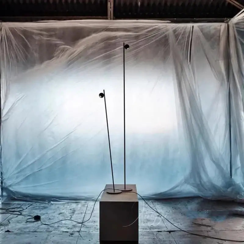 Decorbites black led floor lamp with slender metal poles and spherical heads on a matte concrete base for minimalist decor