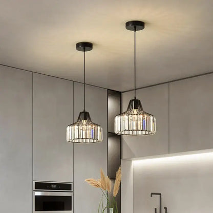 Two modern decorbites black led pendant chandeliers with black metal frames and clear glass rods for kitchen dining room