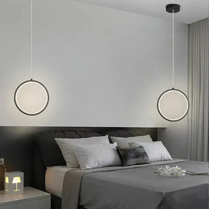 Modern circular decorbites black led pendant light with sleek black frame and glowing white led ring for elegant bedrooms
