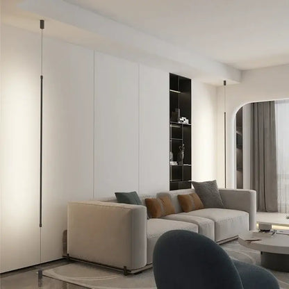 Beige upholstered sectional sofa with gray and brown pillows under decorbites black led pendant light for modern decor