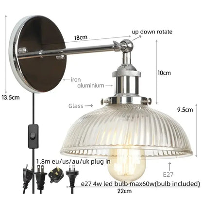 A sleek decorbites black led wall lamp with polished chrome finish and ribbed glass shade for bedside lighting
