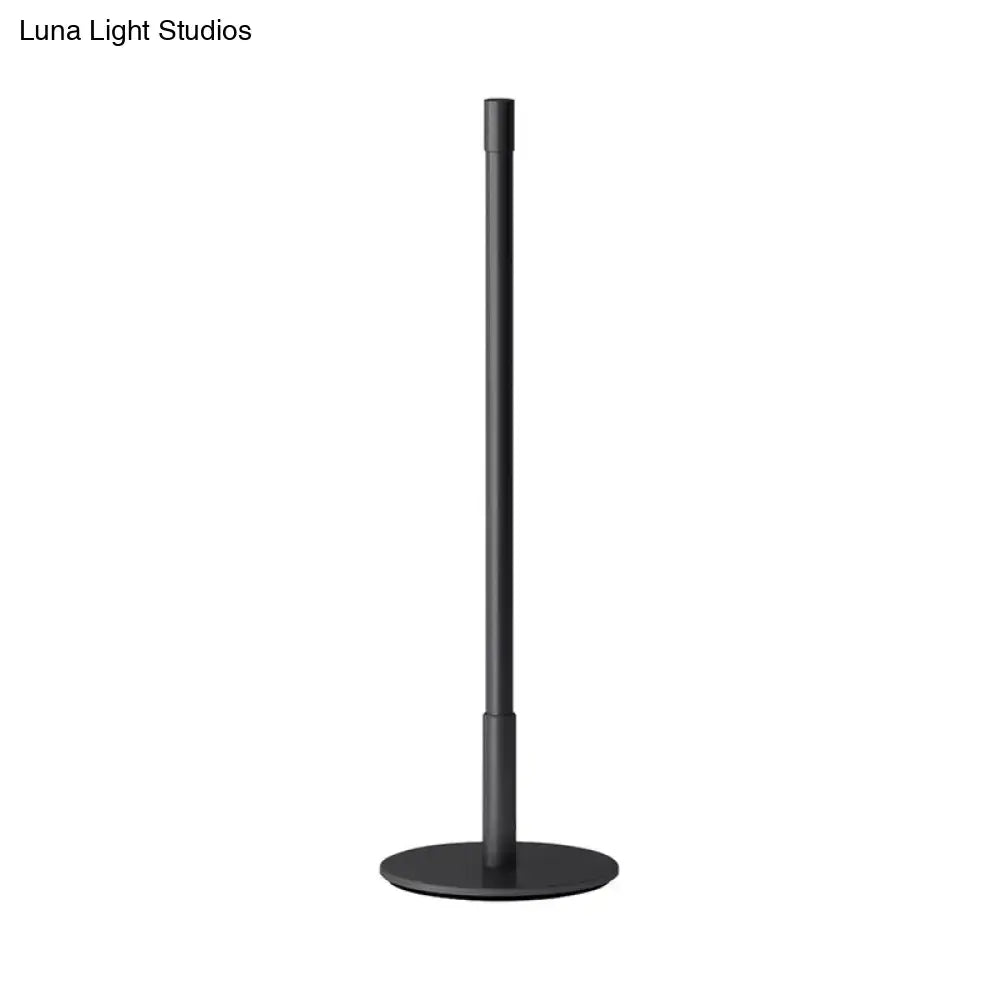 Black metal plumb rod LED night light with circular base, a sleek bedside table lamp from DecorBites™