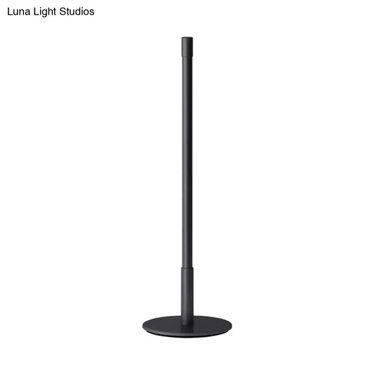 Black metal plumb rod LED night light with circular base, a sleek bedside table lamp from DecorBites™