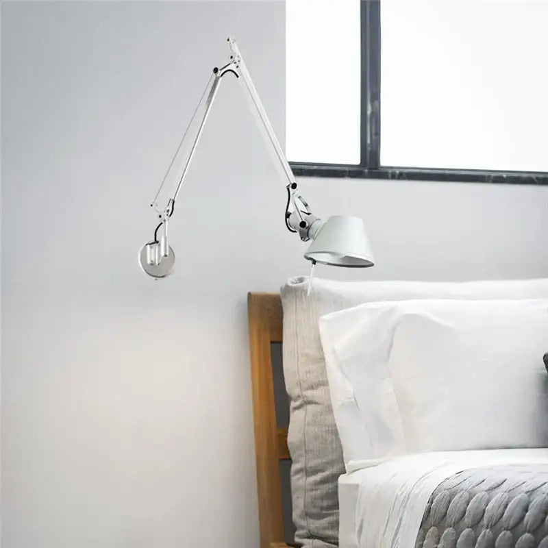 A sleek decorbites black silver rotatable wall light with articulated metallic joints for study or office use